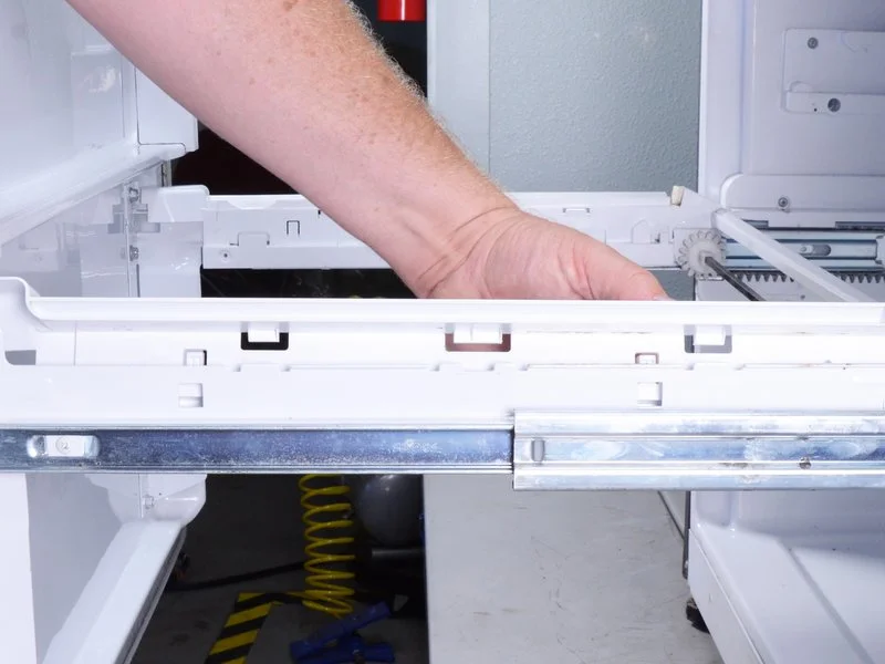image of a person which Remove the drawer rail covers