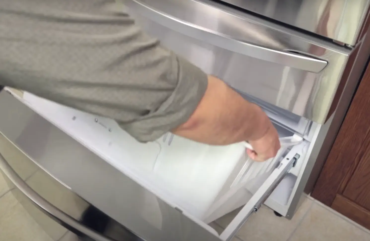 Image of removing the lower basket from the freezer