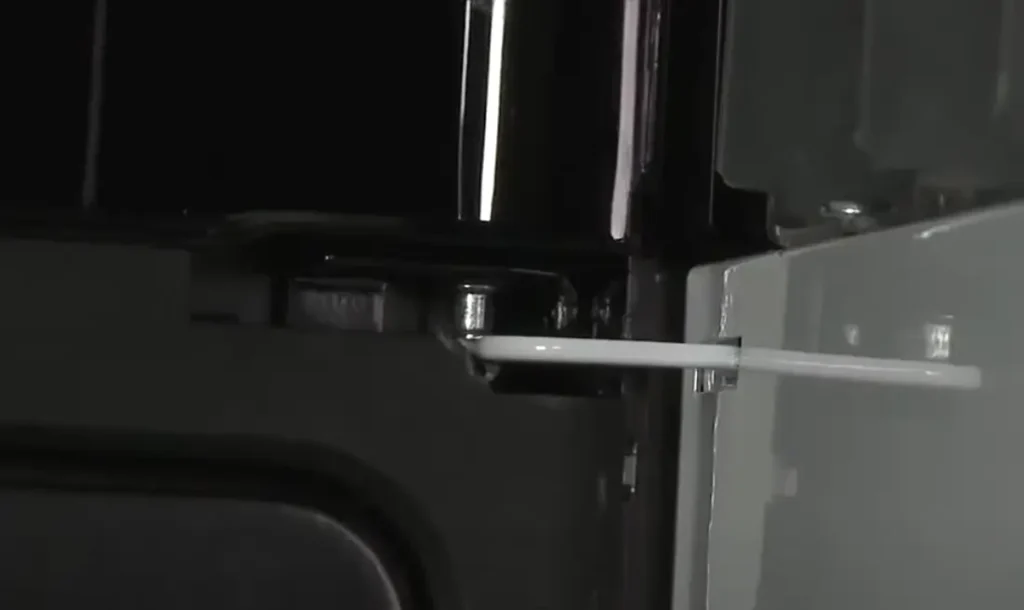 Image of fitting microwave door on upper side